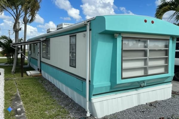 Refurbished container home exterior, light blue accents, modern design