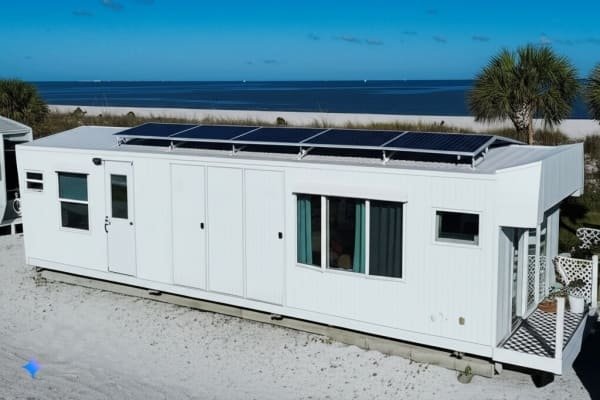 Container home with solar panels, beachside living, sustainable energy